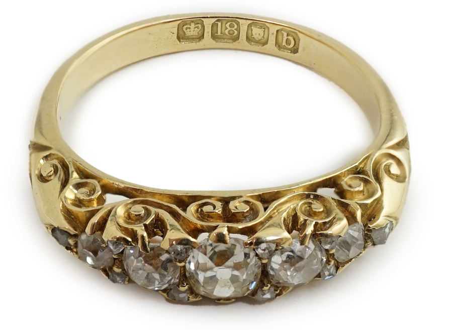 A late Victorian 18ct gold and graduated seven stone diamond set half hoop ring